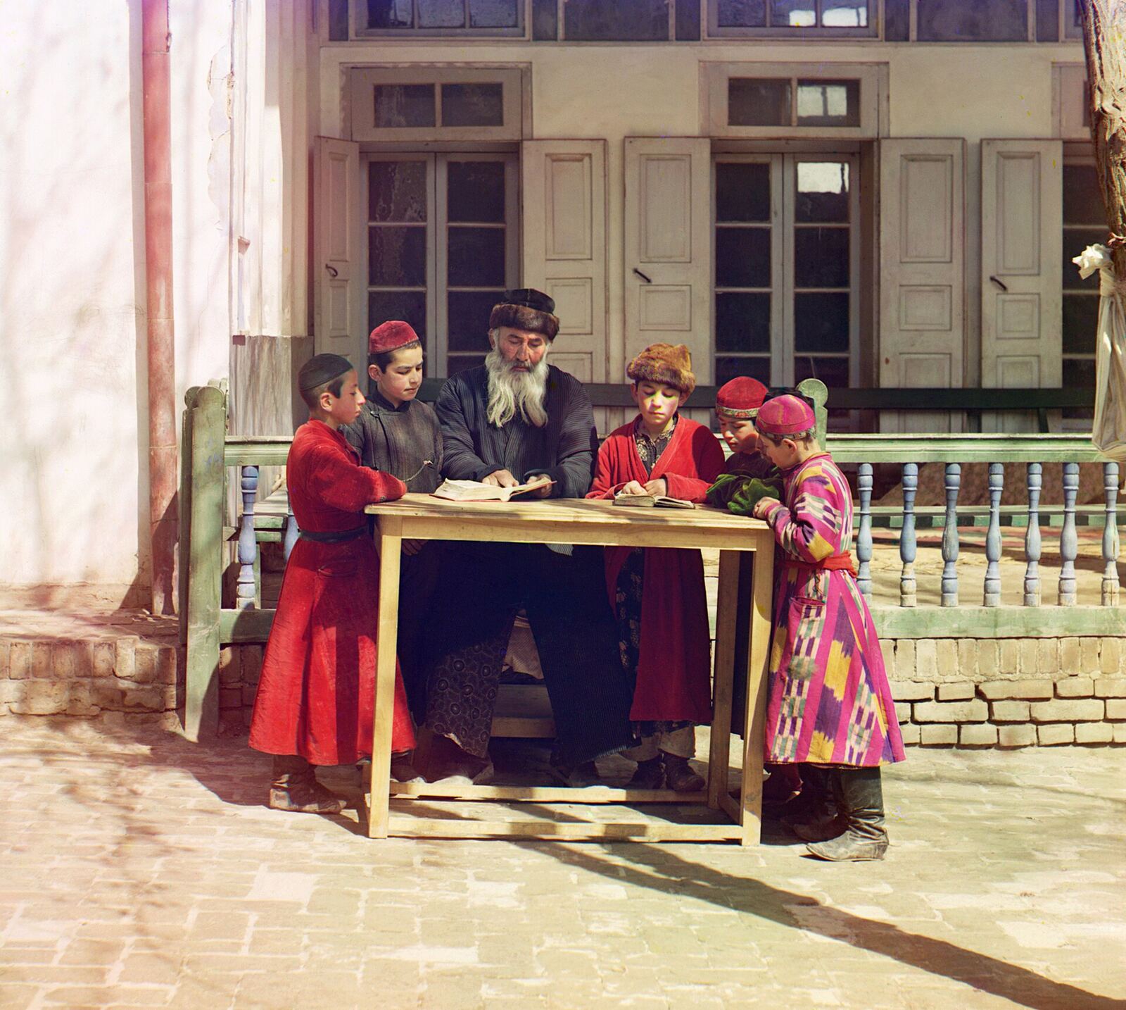 Jewish Children with their Teacher in Samarkand . Early color photograph from Russia, created by Sergei Mikhailovich Prokudin-Gorskii as part of his work to document the Russian Empire from 1909 to 1915.